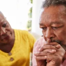 Man facing prostate cancer anxiety being comforted by wife