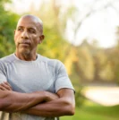 Man with prostate cancer standing outside looking into the distance