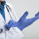 Doctor preparing to perform digital rectal exam for prostate cancer