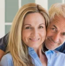 Older couple smiling on couch