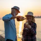 Couple drinking champagne on the beach