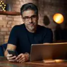 older man on laptop at desk